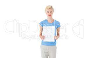 Stern blonde woman holding sheet of paper