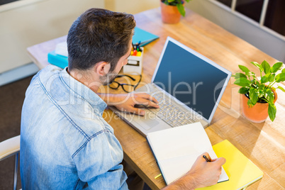 Casual businessman taking notes in his notepad