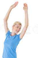 Blonde woman standing eyes closed and arms up