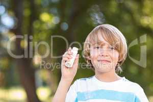 Little boy using his inhaler