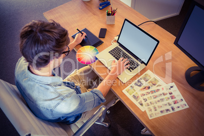 Happy designer working on his laptop