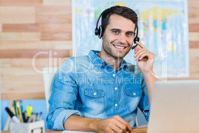 Handsome travel agent smiling at camera