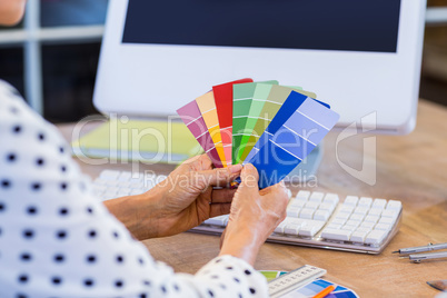 Casual businesswoman looking at colour swatch