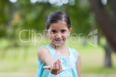 Little girl showing his inhaler