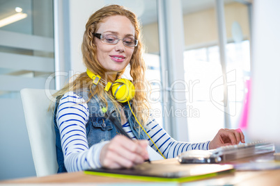 Smiling designer working with digitizer