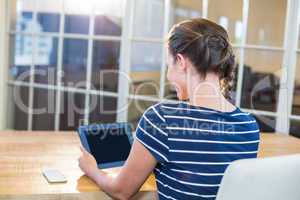 Smiling brunette holding tablet