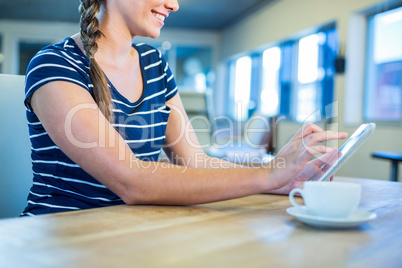 Smiling brunette using tablet