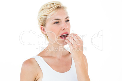 Pretty blonde woman ready to swallow red pill