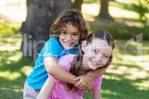 Little siblings smiling at camera