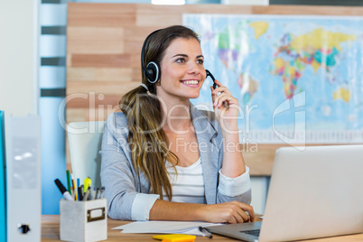 Pretty travel agent speaking to customer