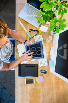 Casual businessman working on tablet