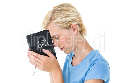 Pretty blonde woman holding bible