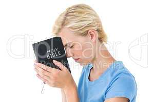 Pretty blonde woman holding bible