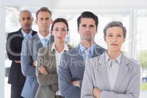 Business people standing in a row arms crossed