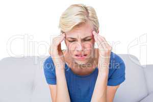 Attractive blonde woman having headache