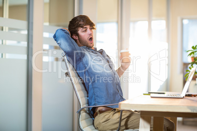 Tired businessman sitting at desk