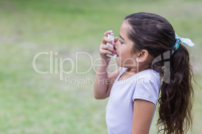 Little boy using his inhaler