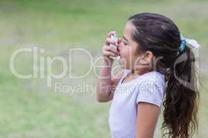 Little boy using his inhaler