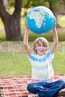 Little boy holding a globe