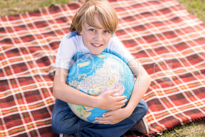 Little boy holding a globe