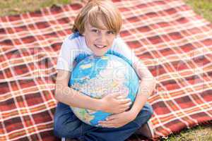 Little boy holding a globe