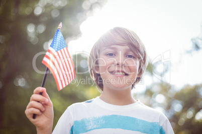 Young boy holding an american flag