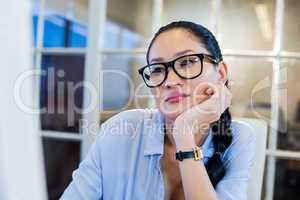 Thoughtful businesswoman sitting at her desk