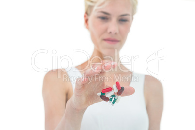 Blonde woman throwing away batch of pills