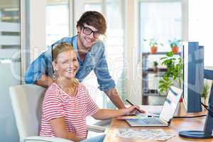 Smiling team working with digitizer and laptop