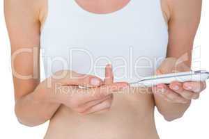 Woman doing test with blood glucose monitor