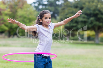 happy girl playing with hula hoops