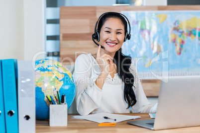 Pretty travel agent smiling at camera