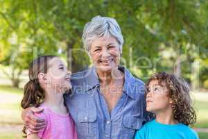 Extended family smiling and kissing in a park