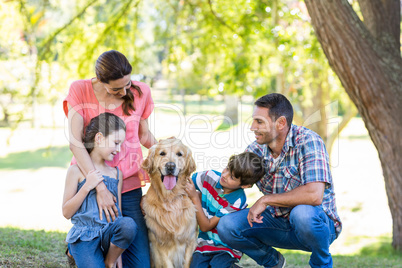 Happy family with their dog in the park