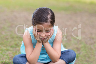 Little boy feeling sad in the park