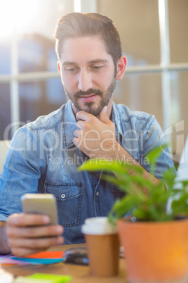 Casual businessman texting with his mobile phone