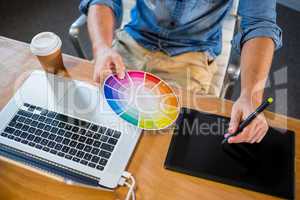 Designer working with colour wheel and digitizer