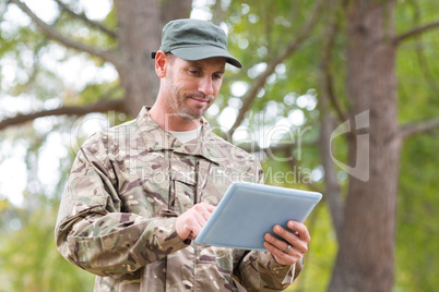 Soldier looking at tablet pc in park