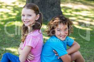 Little siblings smiling at camera