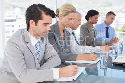 Business team taking notes during conference