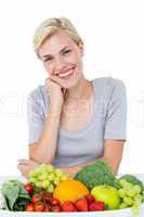 Happy blonde woman sitting above healthy food