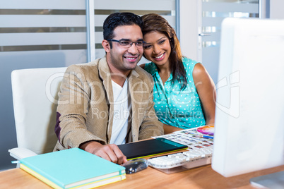 Happy partners working together on computer