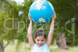 Little girl holding a globe