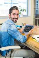 Casual businessman working at his desk with tablet