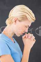 Pretty blond woman praying