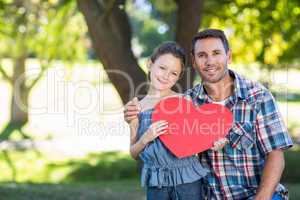 Father and daughter smiling in the park