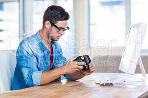 Casual businessman holding digital camera