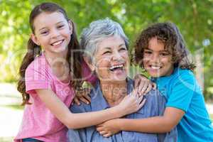 Extended family smiling and kissing in a park