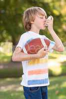 Little boy using his inhaler