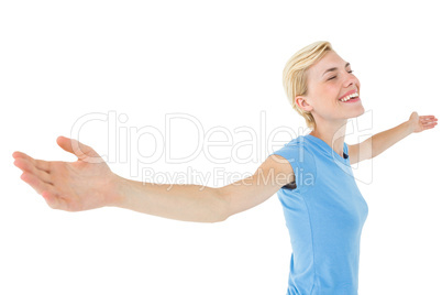 Blonde woman standing arms outstretched